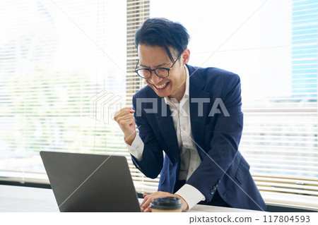 A man who is happy and makes a fist pump A man who is happy and makes a fist pump 117804593