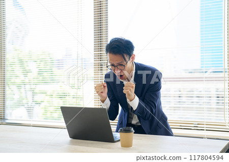 A man who is happy and makes a fist pump A man who is happy and makes a fist pump 117804594