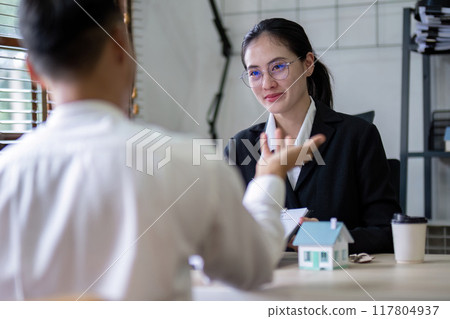 Client and Real Estate Agent Negotiating Home Purchase Details Client and Real Estate Agent Negotiating Home Purchase Details 117804937