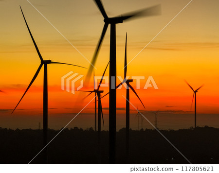 Wind farm field and sunset sky. Wind power. Sustainable, renewable energy. Wind turbines generate electricity. Sustainable development. Green technology for energy sustainability. Eco-friendly energy. 117805621