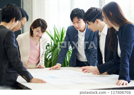 Office workers having a meeting in the office 117806708