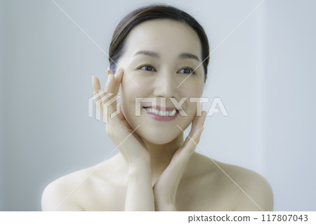 Young woman taking care of her facial skin Young woman taking care of her facial skin 117807043