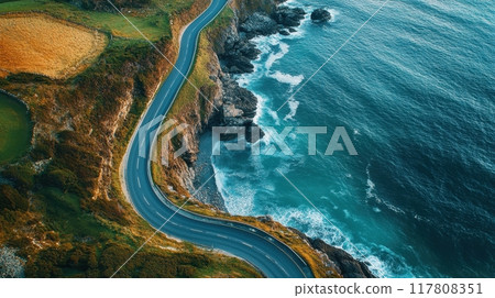 Aerial View of a Scenic Coastal Road Winding Along Rugged Cliffs and Turquoise Ocean Waves Aerial View of a Scenic Coastal Road Winding Along Rugged Cliffs and Turquoise Ocean Waves 117808351