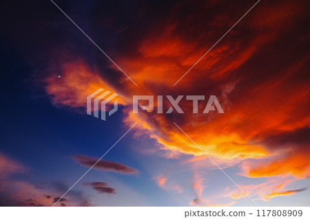 beautiful orange and blue sky with a large cloud in the middle beautiful orange and blue sky with a large cloud in the middle 117808909