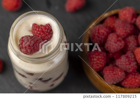 delicious and fresh yogurt with raspberry flavor and whole red raspberries delicious and fresh yogurt with raspberry flavor and whole red raspberries 117809215