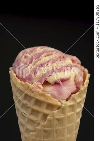 waffle cone with ice cream and pieces of melon and watermelon 117809265