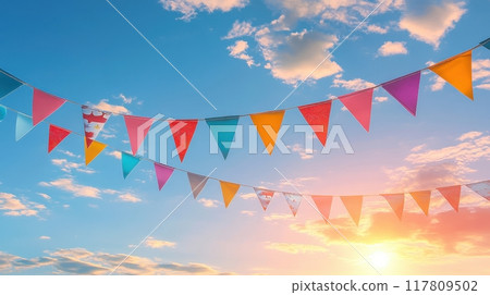 Colorful Pennant Flags Against a Vibrant Sunset Sky with Puffy Clouds Colorful Pennant Flags Against a Vibrant Sunset Sky with Puffy Clouds 117809502