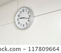 Analog wall clock on a white wall 117809664