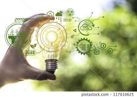 green energy concept help reduce global warming..Hand holding natural background light bulb on green leaf with clean energy icon around it. Carbon dioxide emission in industry zero carbon concept.. green energy concept help reduce global warming..Hand holding natural background light bulb on green leaf with clean energy icon around it. Carbon dioxide emission in industry zero carbon concept.. 117810625