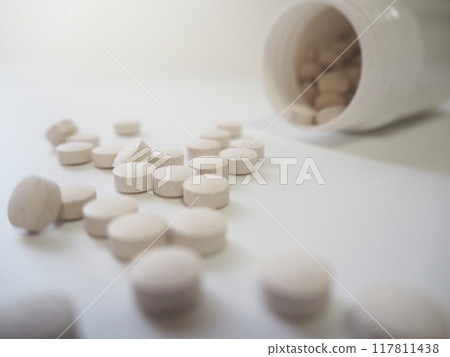 Tablet supplements spilling out of a bottle Tablet supplements spilling out of a bottle 117811438