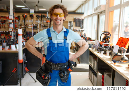 Portrait of well-equipped mechanic worker wearing uniform and tools belt 117811592