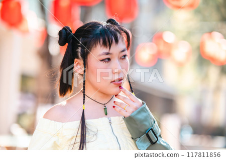Portrait of an Asian woman against the background of Chinese lanterns. Portrait of an Asian woman against the background of Chinese lanterns. 117811856