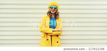 Autumn portrait of beautiful happy smiling woman in yellow french hat, stylish trendy girl posing 117812106