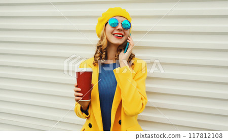 Autumn portrait of happy smiling young woman calling on phone, stylish girl talking on a smartphone 117812108