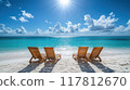 Idyllic Tropical Beach with Four Wooden Lounge Chairs Facing Turquoise Ocean Under a Bright Sunny Sky 117812670