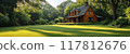 Charming Wooden Cabin in a Lush Green Forest with Sunlight Streaming Through Trees 117812676