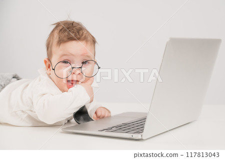 Cute baby in glasses and suit working on laptop. Cute baby in glasses and suit working on laptop. 117813043