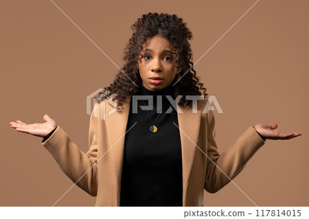 Dissatisfied indifferent african teenager girl, can't help, gesture of dont know 117814015