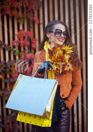 smiling woman in orange trench coat smiling woman in orange trench coat 117815262