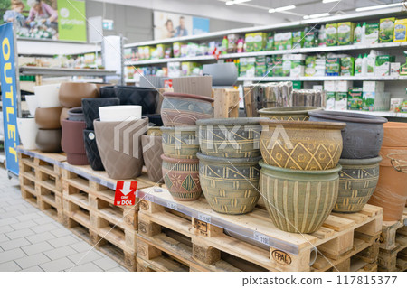Many colorful flower pots in different sizes in a gardening store. Rows of decorative ceramic pots for houseplants. Ceramic and clay pottery 117815377