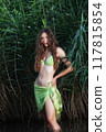 Mystical beauty in the green: Young woman in green bikini in front of reeds 117815854