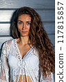 Portrait of a young woman in a boho lace dress 117815857