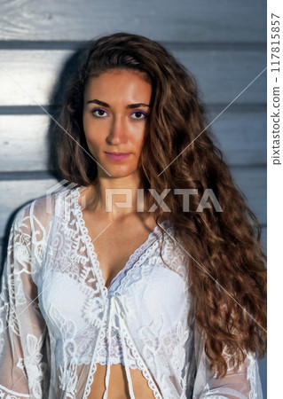 Portrait of a young woman in a boho lace dress Portrait of a young woman in a boho lace dress 117815857