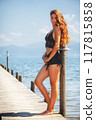 Sensual summer portrait of a young woman in black lace by the lake 117815858
