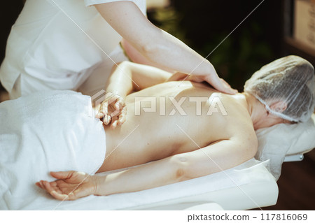 medical massage therapist in spa salon massaging client medical massage therapist in spa salon massaging client 117816069