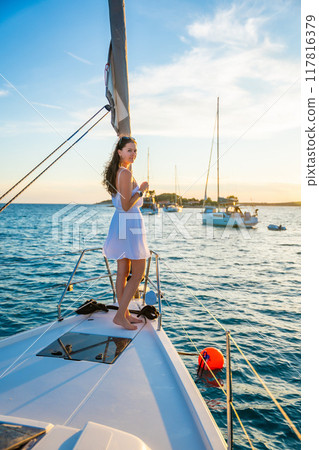 Young woman sailing, young adult lady enjoying summer travel, close-up portrait of female face, summer cruise holidays, European girl tourist traveling in sail boat in Croatia 117816379