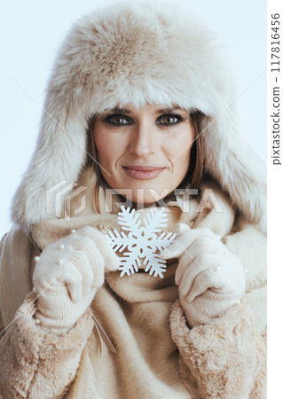 happy stylish woman in winter coat and fur hat on white 117816456