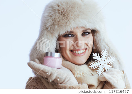 smiling modern woman in winter coat and fur hat on white 117816457
