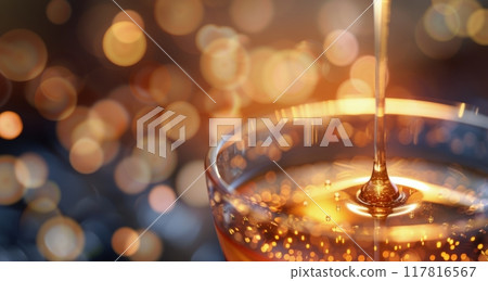 Golden Honey Dripping From Spoon Into Cup Amidst Warm Bokeh Lights 117816567