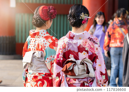 Young girl wearing Japanese kimono standing in front of Sensoji Temple in Tokyo, Japan. Kimono is a Japanese traditional garment. The word kimono, which actually means a thing to wear Young girl wearing Japanese kimono standing in front of Sensoji Temple in Tokyo, Japan. Kimono is a Japanese traditional garment. The word kimono, which actually means a thing to wear 117816608