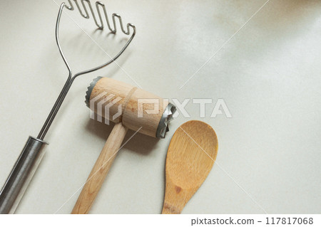 Kitchen utensils for mashing potatoes and meat tenderizer with wooden spoon 117817068