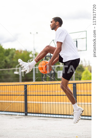 Tall young man in sportswear warming up before the game 117817720