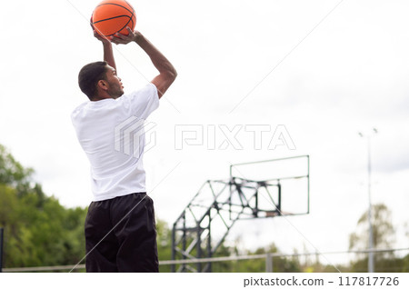 Male basketball player throwing the ball to the basket 117817726