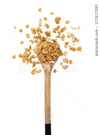 crunchy granola in wooden spoon isolated on white 117817895