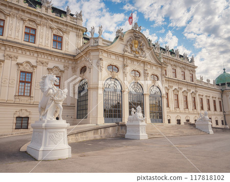 Wien, Austria - July 28, 2023: Belvedere Palace in summer sunny day. Baroque beautiful facade with statues and bas-reliefs of Lower Belvedere. Wien, Austria - July 28, 2023: Belvedere Palace in summer sunny day. Baroque beautiful facade with statues and bas-reliefs of Lower Belvedere. 117818102