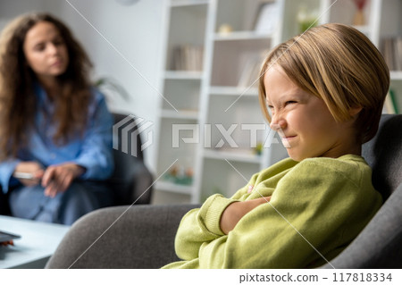 Blonde boy looking upset and unhappy during speech therapy Blonde boy looking upset and unhappy during speech therapy 117818334