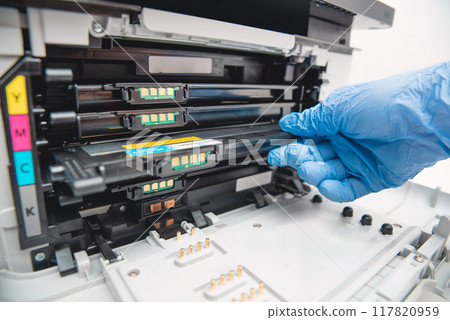 Man replacing cartridge in printer at office 117820959
