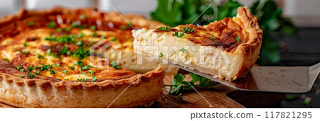 Close-up of a slice of Quiche Lorraine with a crispy crust, creamy filling, and bacon chunks Close-up of a slice of Quiche Lorraine with a crispy crust, creamy filling, and bacon chunks 117821295