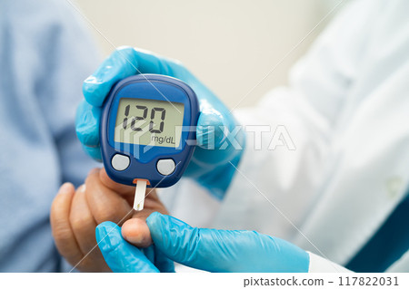Doctor use digital glucose monitor measure and test stripe for check diabetes from finger blood sugar level. Doctor use digital glucose monitor measure and test stripe for check diabetes from finger blood sugar level. 117822031