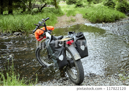 E-Fatbike Crossing a Ford on the Kamenice River During a Bike Tour with Heavy Luggage in Czechia E-Fatbike Crossing a Ford on the Kamenice River During a Bike Tour with Heavy Luggage in Czechia 117822120