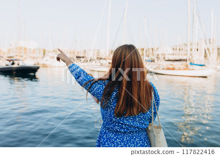 Vacation concept by exploring interesting places to travel. Beautiful Woman Searching locations at summer day. Woman with map walking along the waterfront, seaside. High quality photo Vacation concept by exploring interesting places to travel. Beautiful Woman Searching locations at summer day. Woman with map walking along the waterfront, seaside. High quality photo 117822416