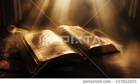 Bible open with light shining on pages Bible open with light shining on pages 117822855