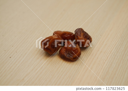Fresh dates on a wooden background 117823625