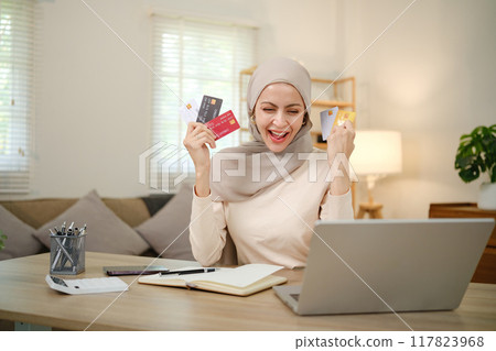 A woman is holding a stack of credit cards and smiling A woman is holding a stack of credit cards and smiling 117823968
