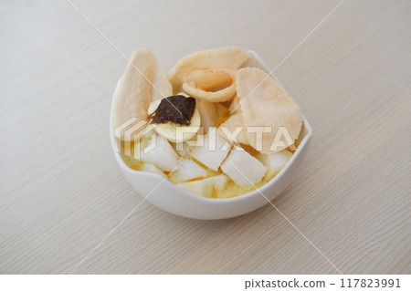 lontong sayur- Compressed rice cake served with curry coconut milk sauce and vegetables and boiled egg 117823991