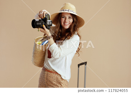 happy stylish woman in blouse and shorts on beige happy stylish woman in blouse and shorts on beige 117824055
